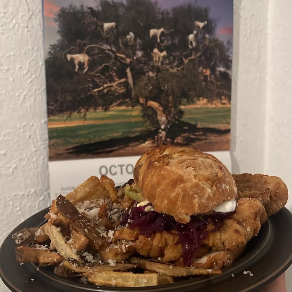 Bacon lardon Gruyère baguette Wiener schnitzel sandwich with French fries covered in truffle salt and parmigiana reggiano