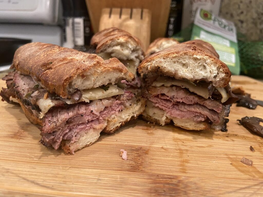 Left over smoked picanha, white cheddar, mushroom sauce, on bread from left over pizza dough I made.