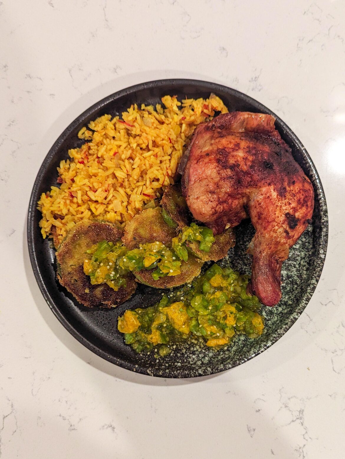Spanish roasted chicken with saffron rice, fried green tomatoes, and a tomatillo orange salsa
