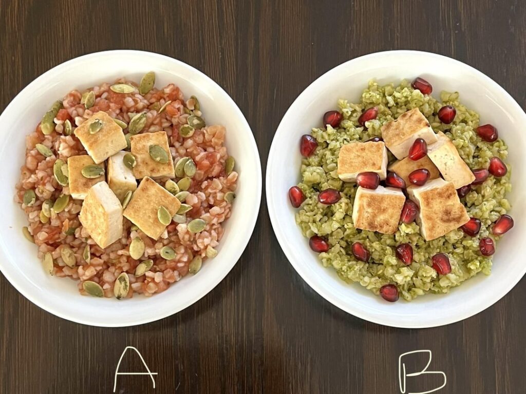 (A) Bulgur wheat with garlic-tomato sauce, pumpkin seeds and toasted tofu. (B) Bulgar wheat with basil pesto, pomegranate seeds and toasted tofu.