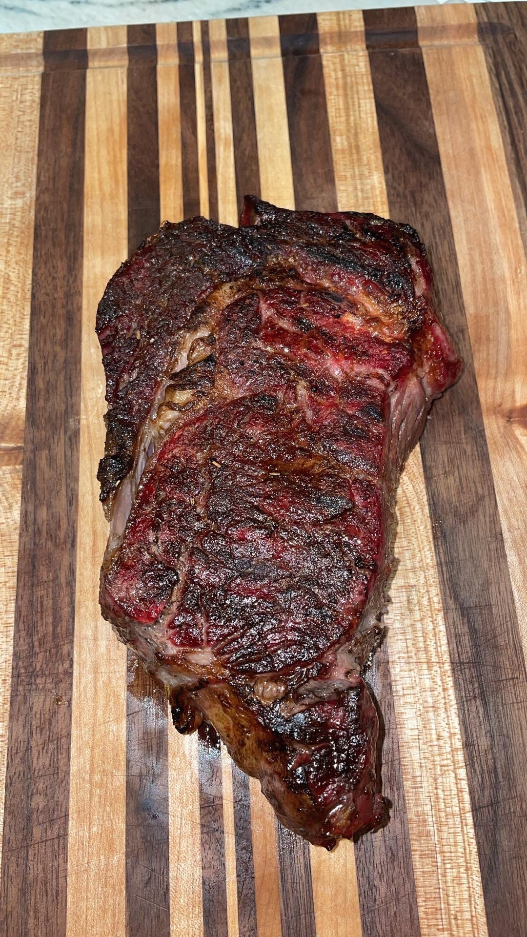 Ribeye smoked and then reverse seared in a er kettle with garlic and