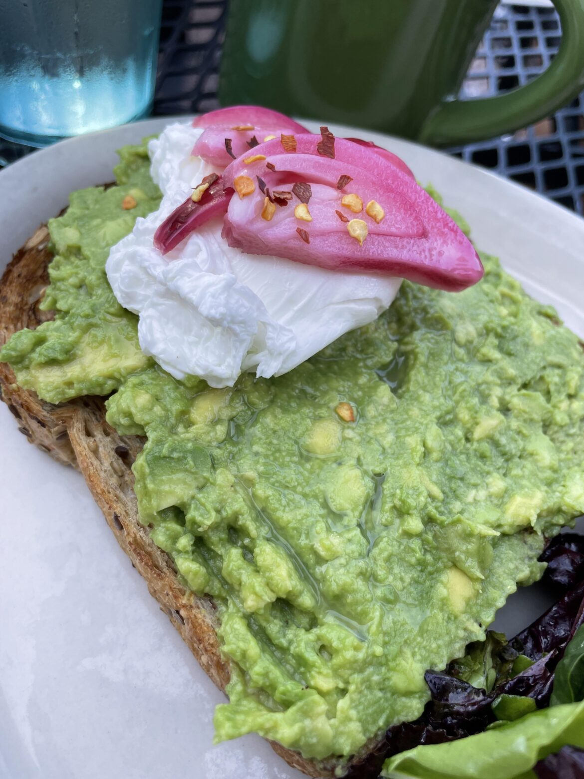 Avocado toast with poached egg and pickled onions