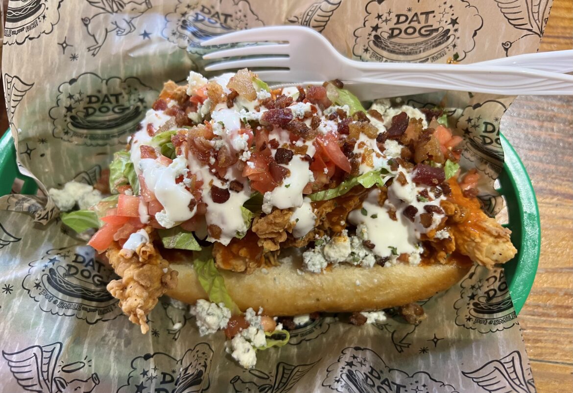I ate a fried chicken sandwich with lettuce and tomato, topped with buffalo sauce, bacon, and blue cheese crumbles
