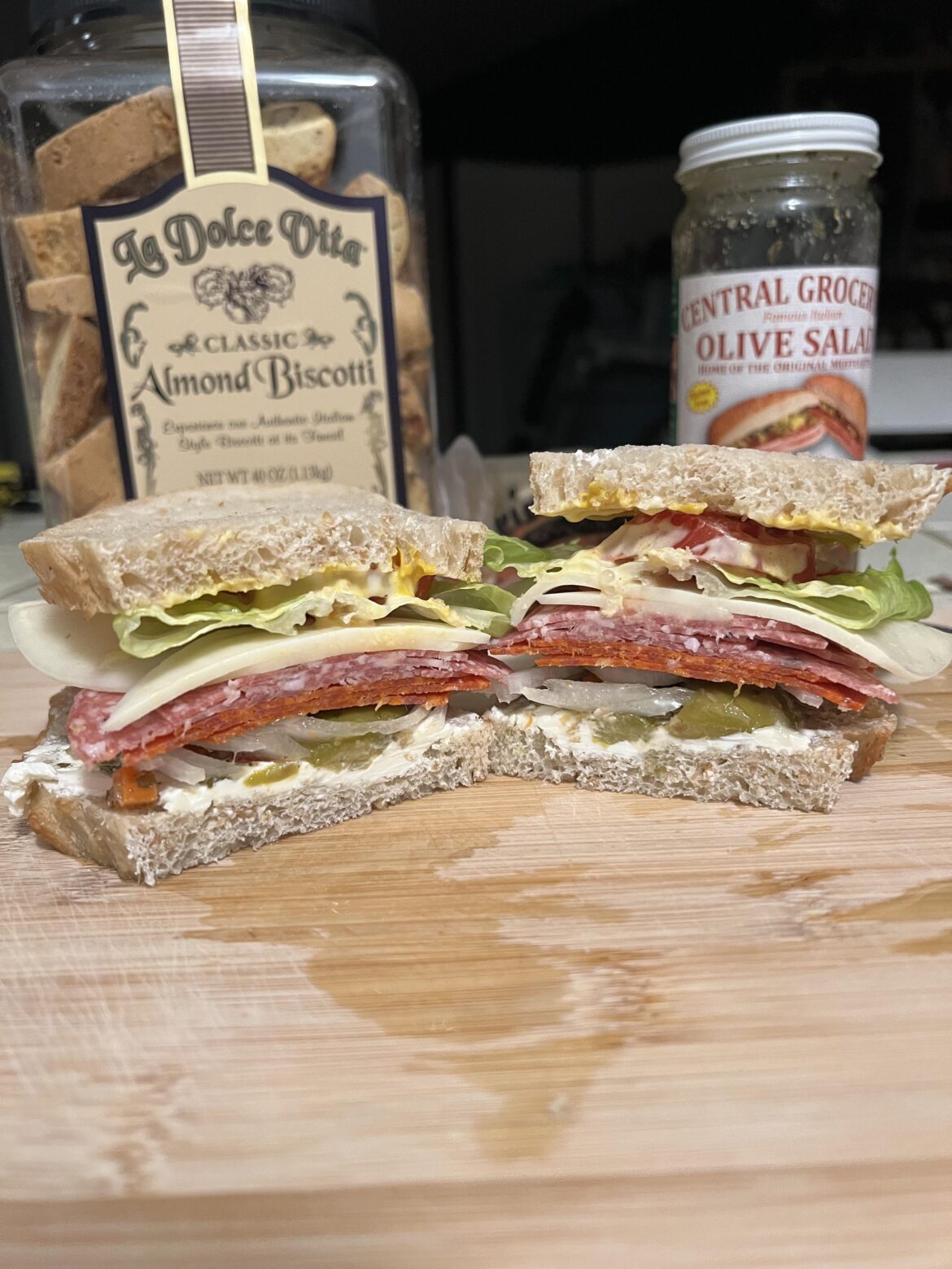 Salami & pepperoni, provolone, cream cheese, olive salad, and onions on cracked wheat sourdough.