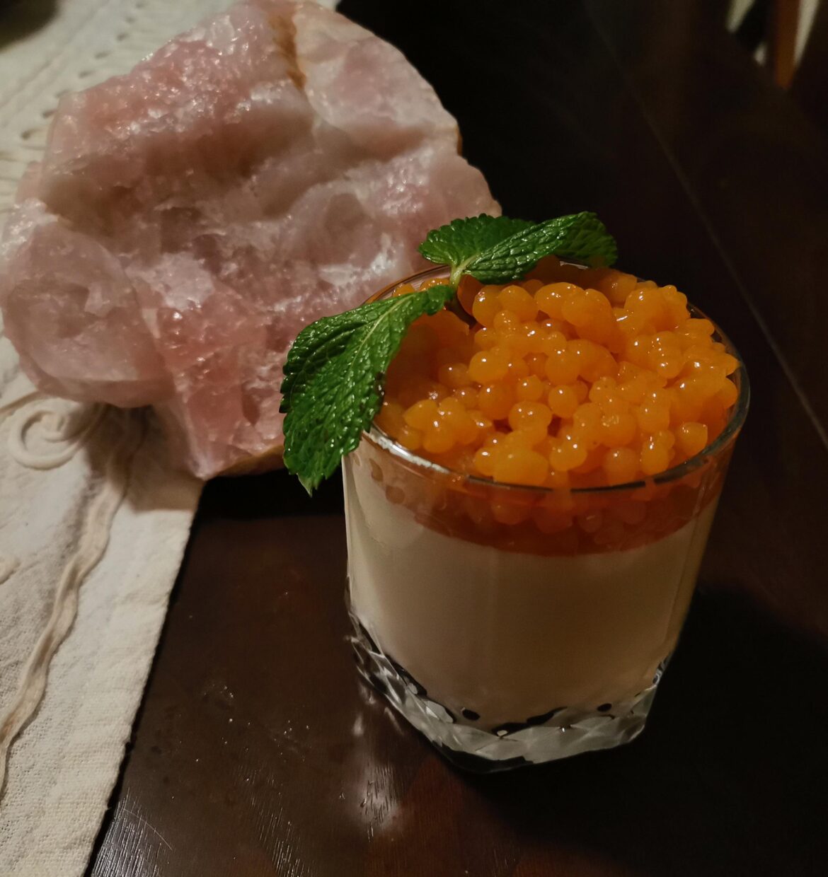Homemade panna cotta with persimmon spherification topping