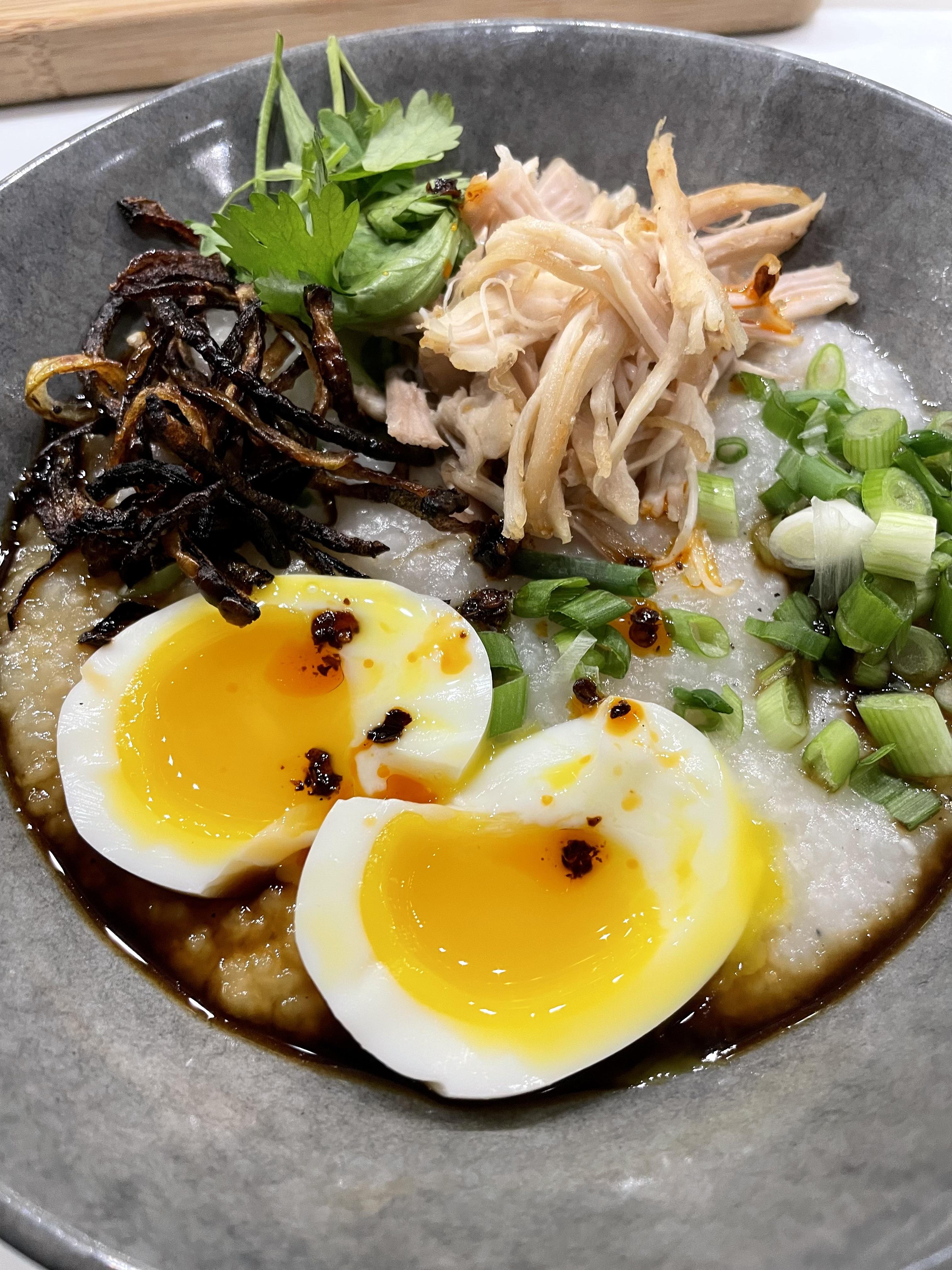 Congee with ginger, topped with chicken, green onion, cilantro, burnt
