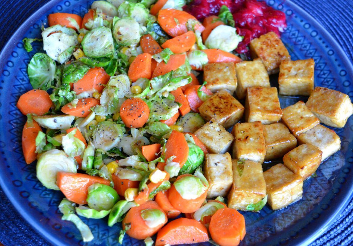 352 cal, 20 g protein. Fall themed plate: cranberry sauce, sweet sesame tofu, and buttered Brussels sprouts with corn and carrots