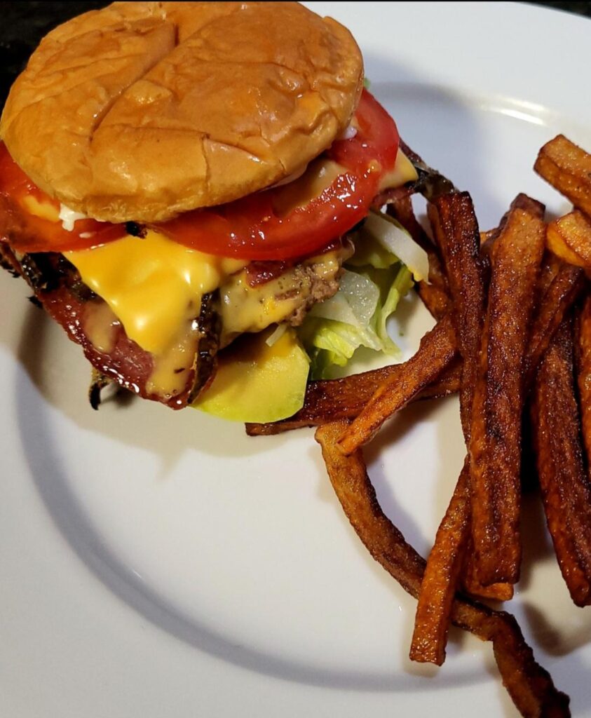 Turkey burger with turkey bacon, grilled jalapeño, onion, tomato, lettuce, avocado, cheese, & fries.