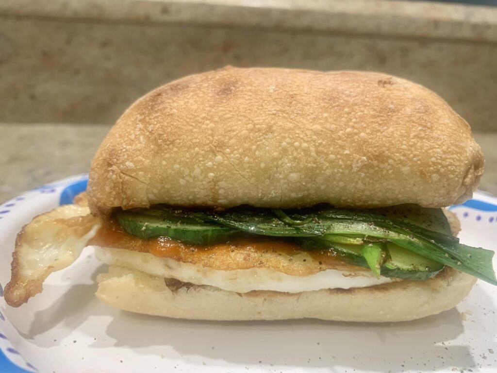 I was craving something a little different this morning. Here’s a sandwich with two fried eggs, fried cucumbers, and green onions, La Choy soy sauce, and the elusive HF Sriracha on a toasted Walmart ciabatta roll. It definitely hit the spot. I was craving something a little different this morning. Here's a sandwich with two fried eggs, fried cucumbers, and green onions, La Choy soy sauce, and the elusive HF Sriracha on a toasted Walmart ciabatta roll. It definitely hit the spot.