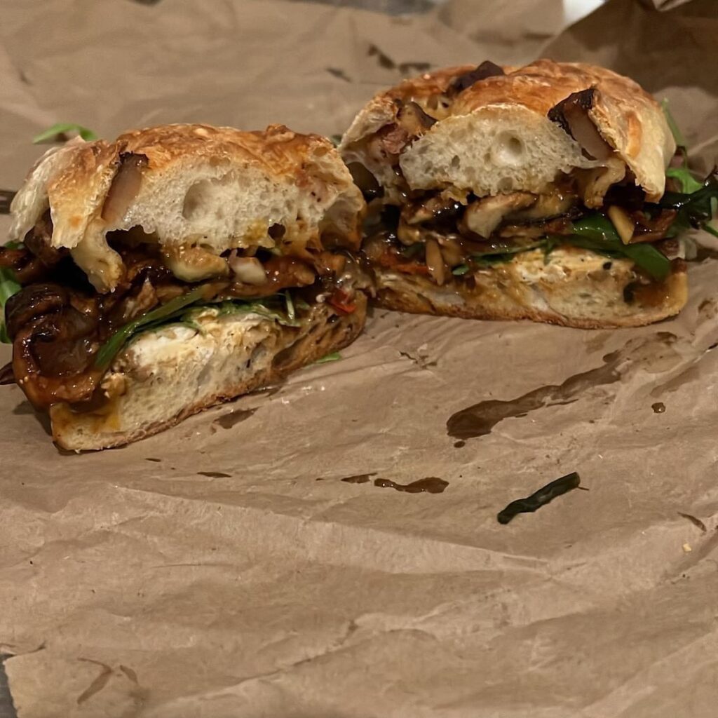 Bacon lardon and Gruyère baguette with isigny spring butter, arugula, pickled onions, Vermont creamery black truffle goat cheese and sautéed shiitakes, shallot, green onion, figs, flavor bomb cherry tomatoes, Thai peppers, and garlic