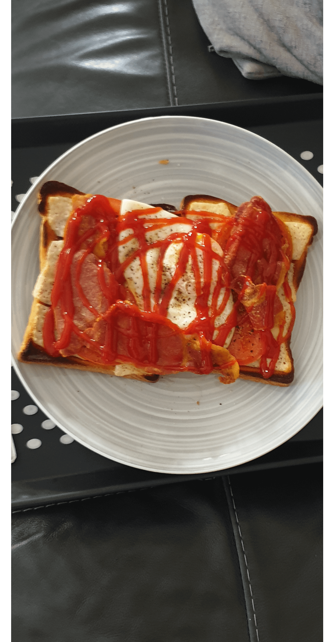 Bacon egg cheese on toast with ketchup and black pepper.. Dining and