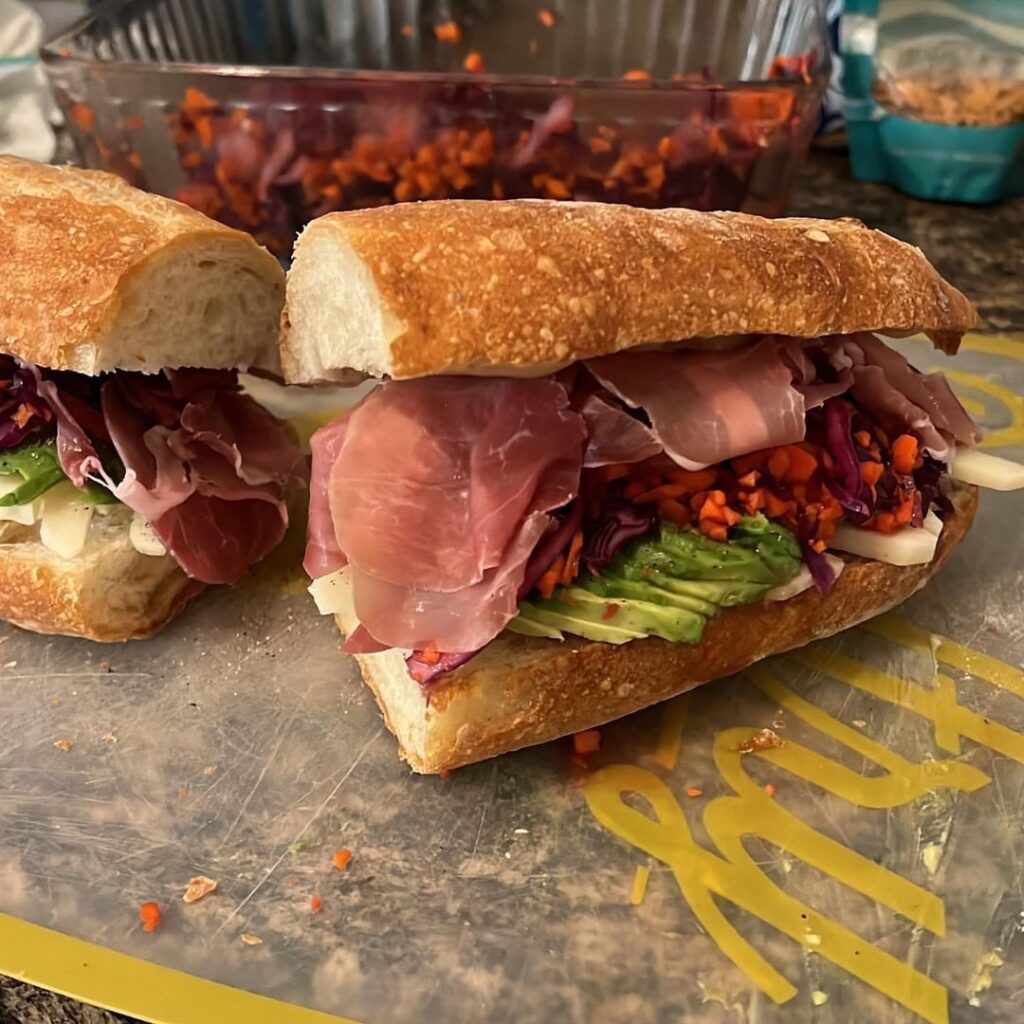 Prosciutto sandwich with manchego, avocado, red cabbage, shallot, habanero, red onion slaw, honey, and butter Prosciutto sandwich with manchego, avocado, red cabbage, shallot, habanero, red onion slaw, honey, and butter