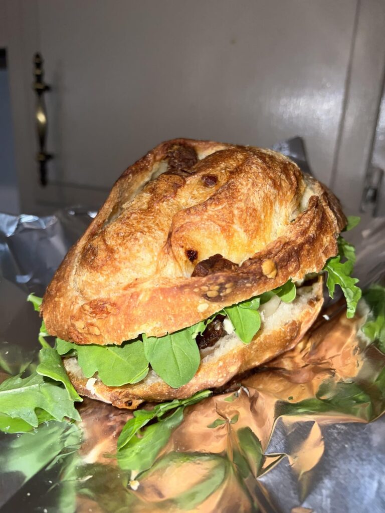 Bacon lardon and Gruyère baguette with butter, lehua blossom honey, walnuts, date, dressed flavor bomb cherry tomatoes, arugula, and rogue river blue