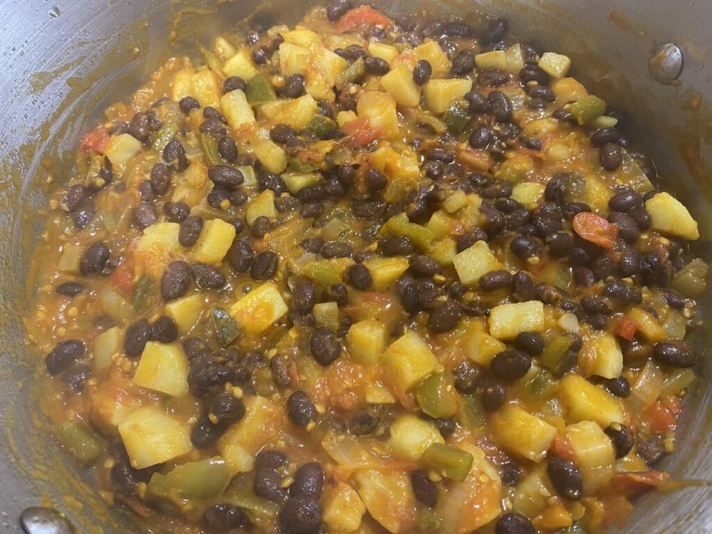 Black bean, potato, tomato, peppers and onion on warm tortillas