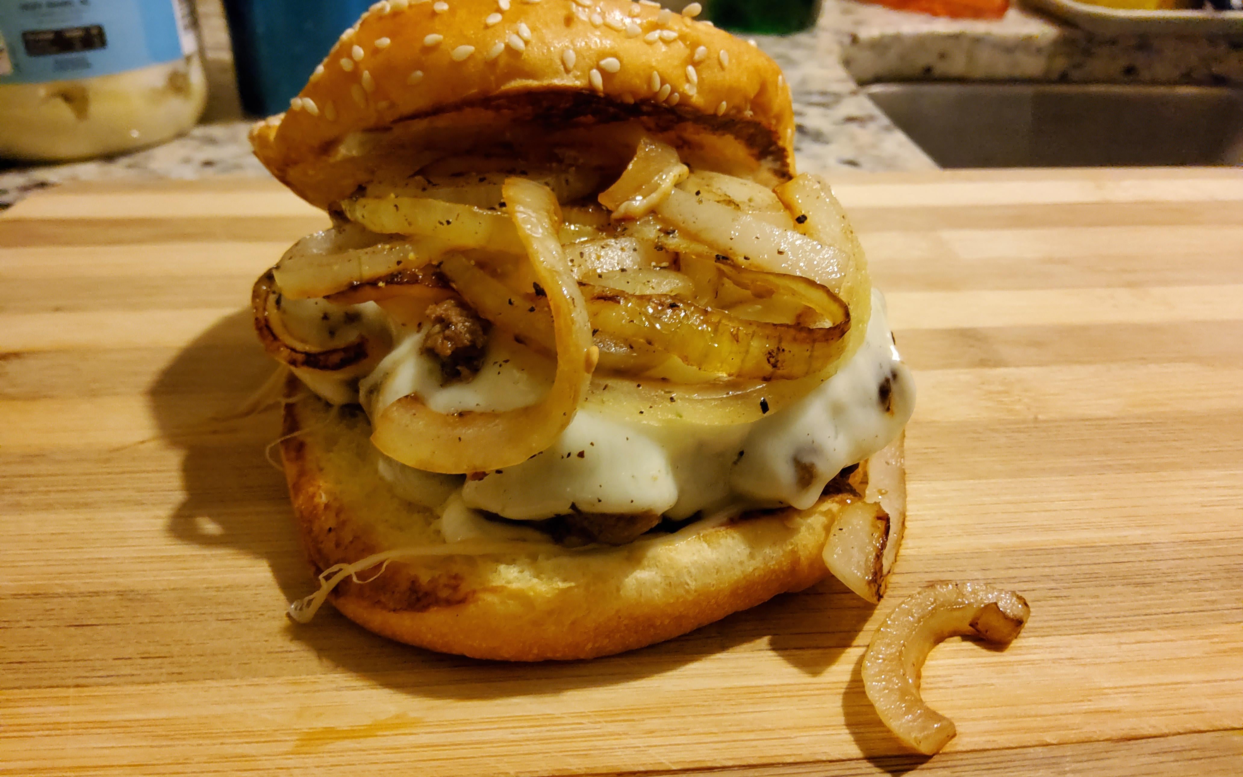 Late night snack. Chuck cheese burger with grilled onions. Dining and