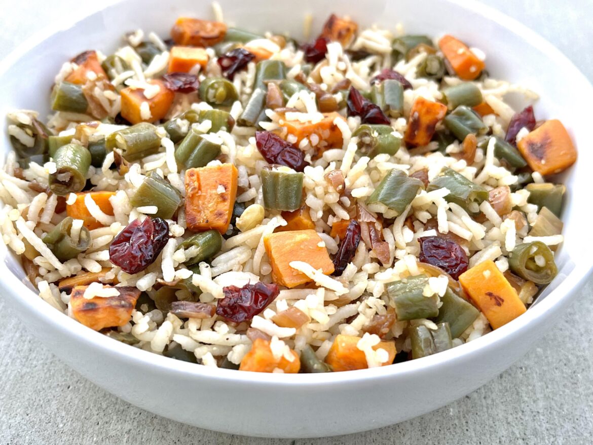Thanksgiving-themed rice with green beans, sweet potato and cranberries.