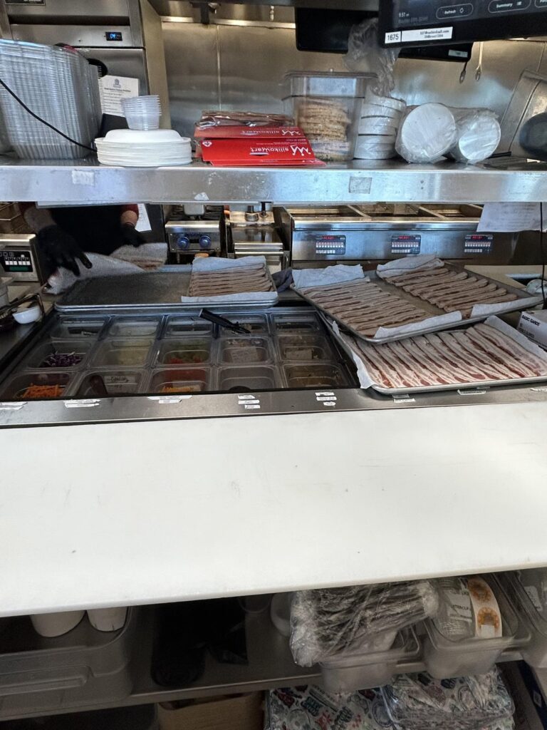 Just left this job because any attempt I made to correct this unsafe food handling was ignored. Yes second photo is raw chicken being breaded next to open sauces. How are people this ignorant???