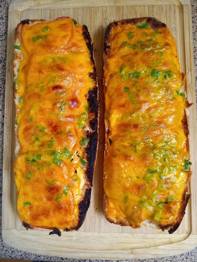 BIG BUBBA'S BUFFALO CHICKEN SANDWICH: Slow cooked shredded buffalo chicken, tomatoes, green onions and sharp cheddar.