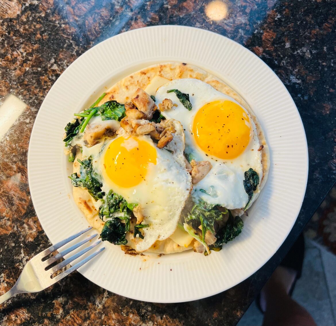 Eggs, spinach, chicken, cheese on grilled pita