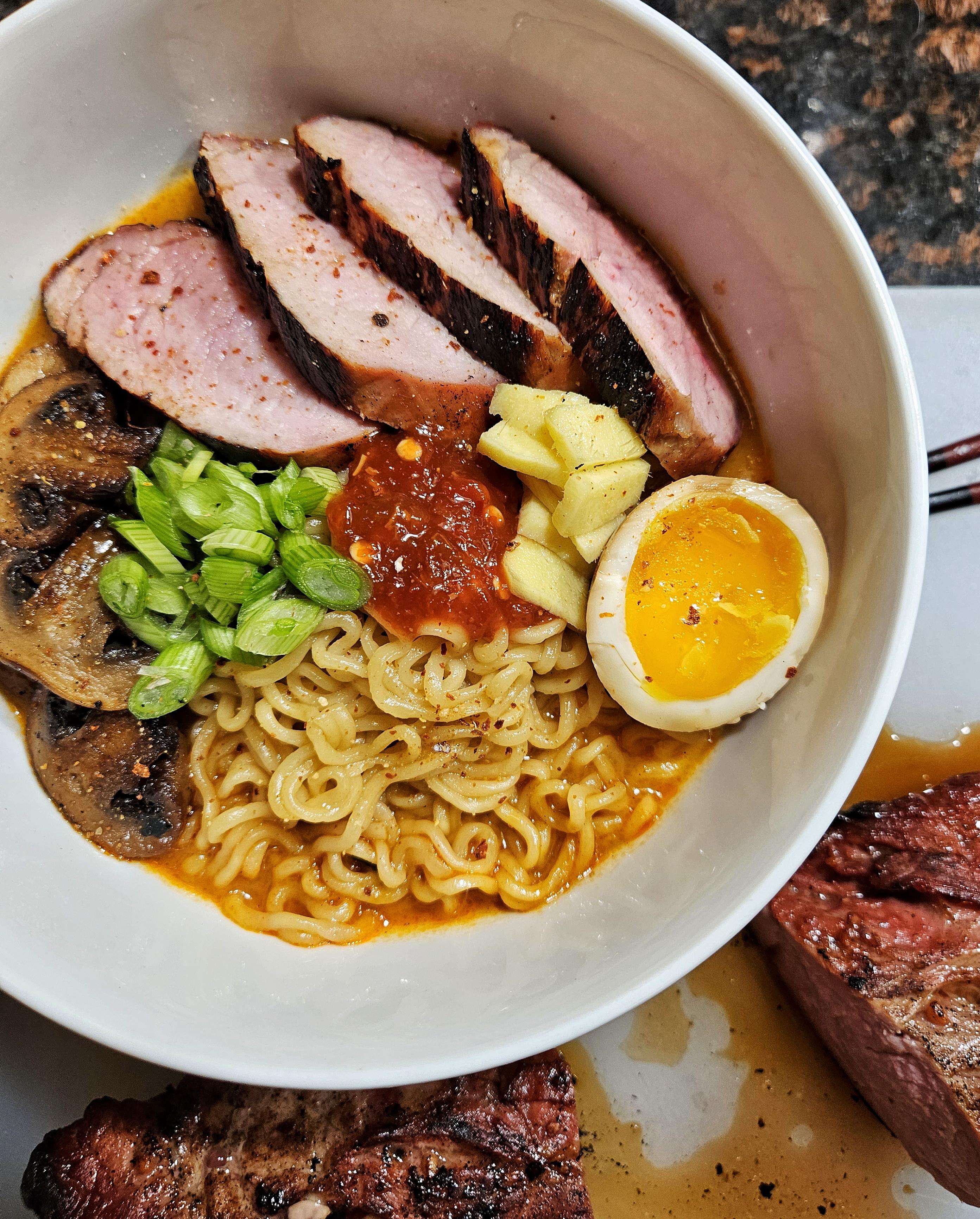 Ramen with roasted pork, miso butter mushrooms, and pickled ginger