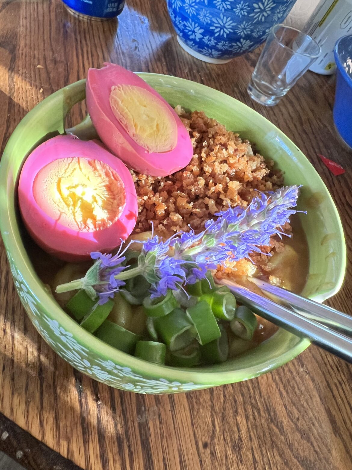 Curry udon with toasted panko, beet pickled egg and green onion