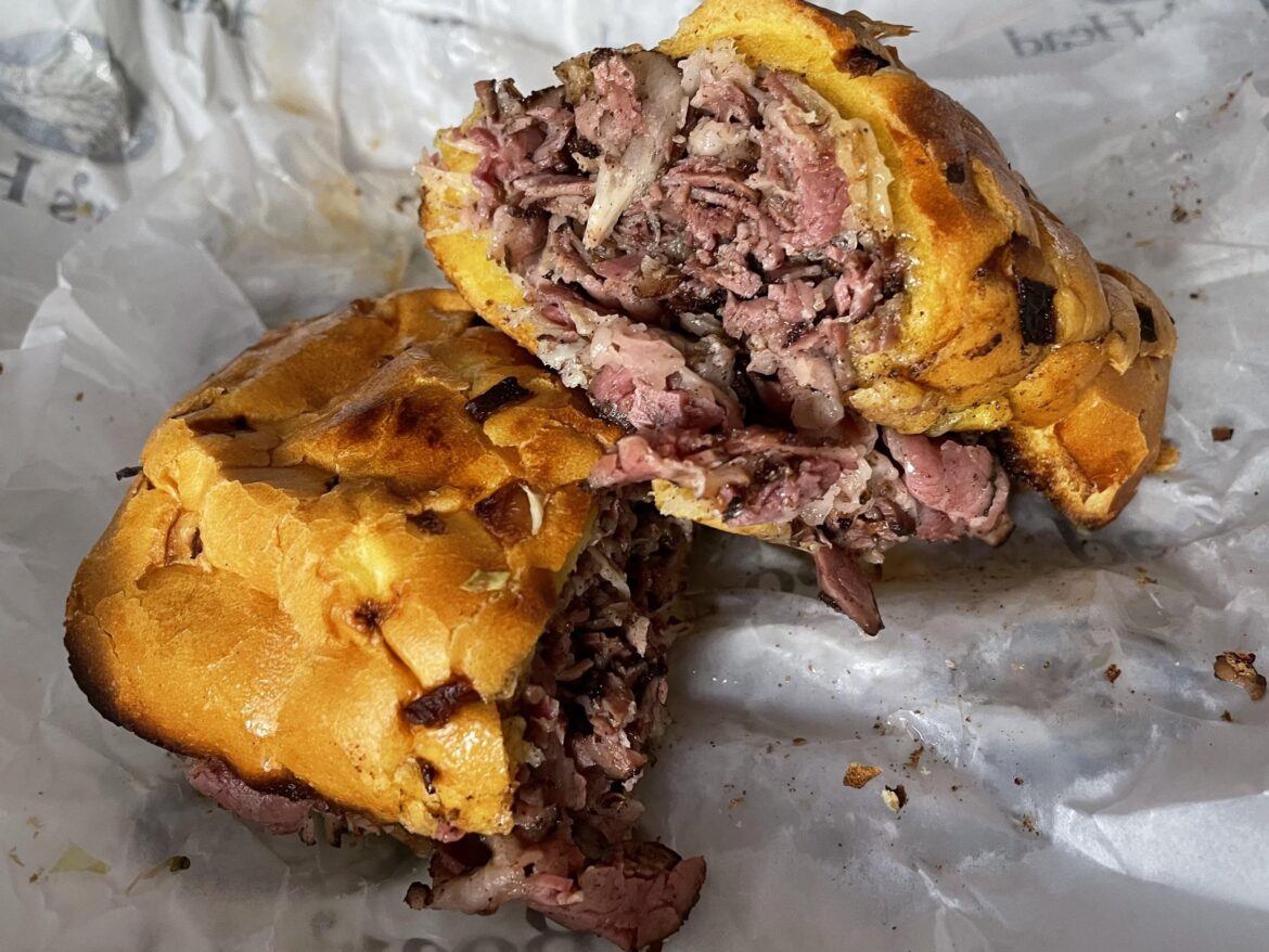 Pastrami and provolone on an onion roll