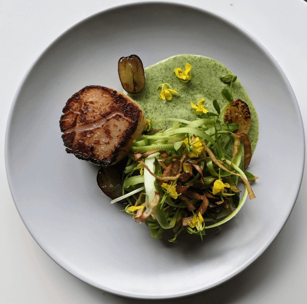 Seared scallop, grape, jalapeno cream, ribbon salad