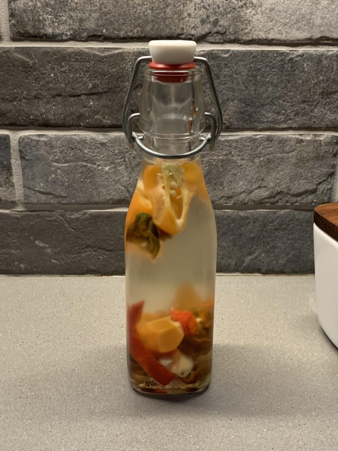 Pepper vinegar is the way to go. This is 100% vinegar with a few habs, choc habs, ghost, clove of garlic and a big pinch of kosher salt. Two weeks in the fridge and it brightens up and accentuates almost anything you can eat. Simple and easy to control the heat.
