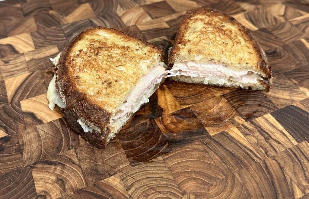 turkey and white cheddar on rye w/onion and dijon.