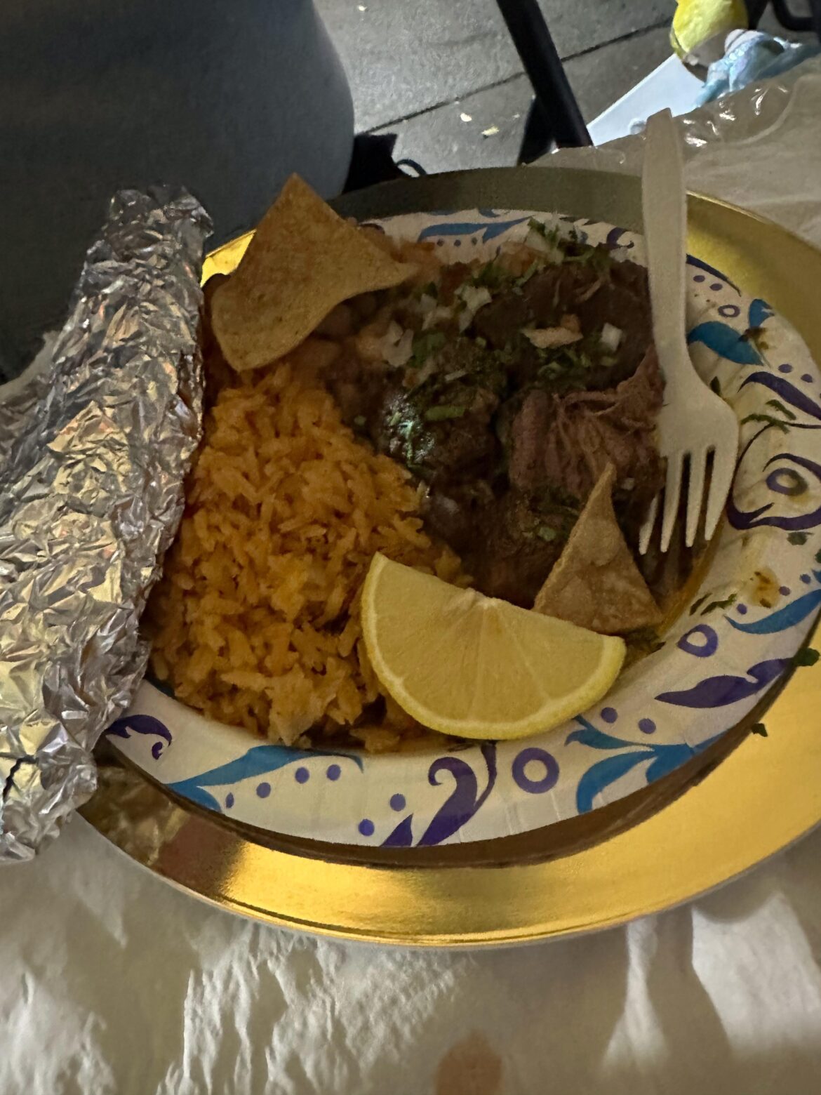 My husband’s birria plate with rice, beans and tortillas.