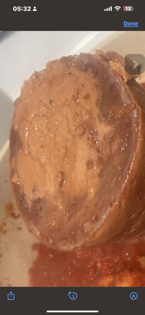 Is this bad? Bottom of refried beans or just settled lard? Discoloration has me worried
