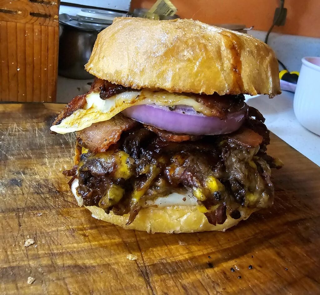 Smoked Chuck Roast, Homemade BBQ Sauce, Peppered Bacon, Fried Egg, Onion, Cheddar