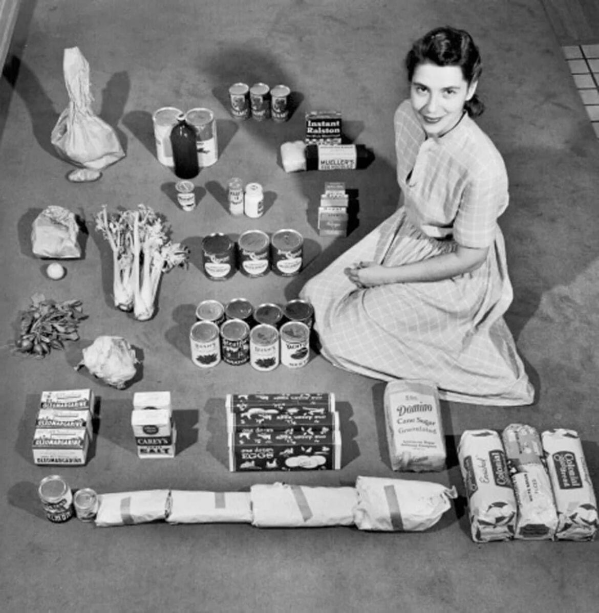 A housewife poses with a week’s worth of groceries in 1947. She spent $12.50 a week to buy all her groceries except milk. On this she managed to feed herself, her husband, her four-year-old twins and the family cat. (Robert Wheeler Time & Life Pictures) A housewife poses with a week's worth of groceries in 1947. She spent $12.50 a week to buy all her groceries except milk. On this she managed to feed herself, her husband, her four-year-old twins and the family cat. (Robert Wheeler Time & Life Pictures)