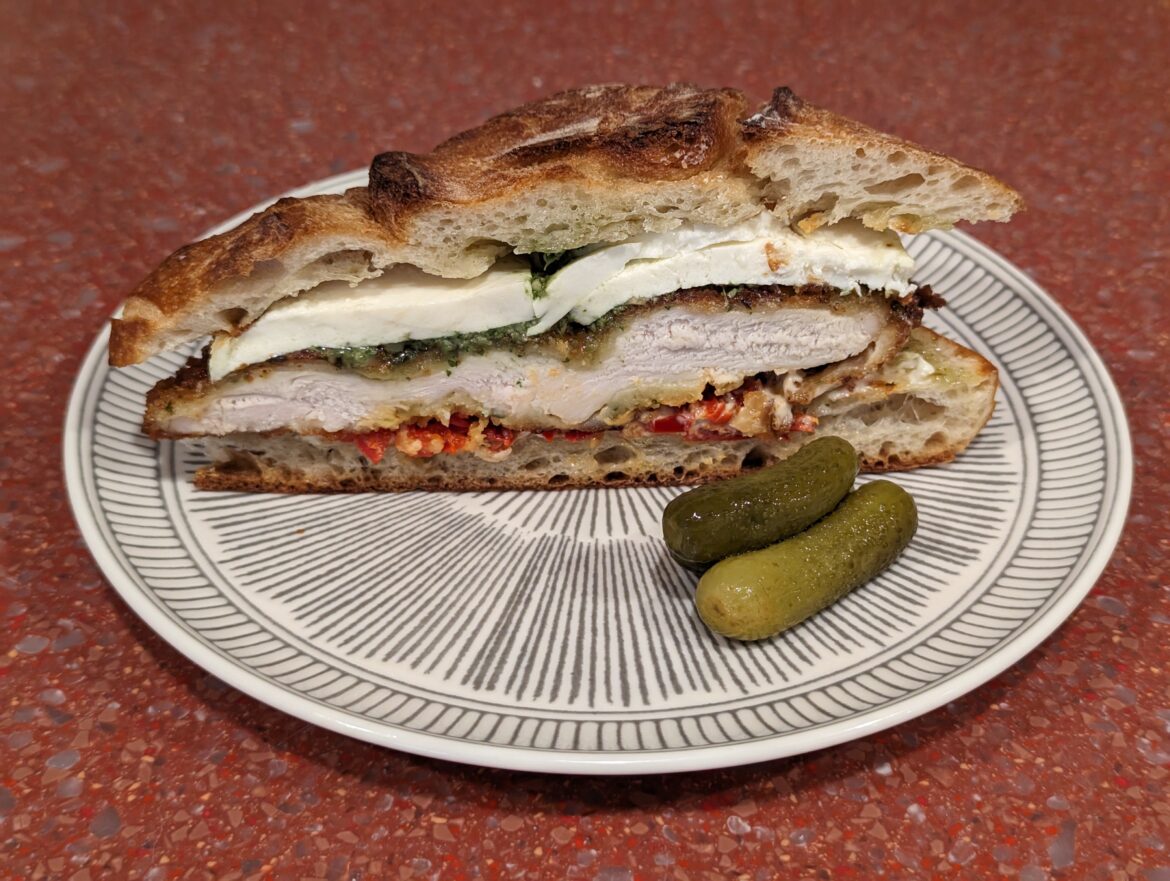 Fried chicken cutlet with fresh mozzarella, pesto, sweet and Calabrian pepper relish, mayo, on olive oil toasted ciabatta