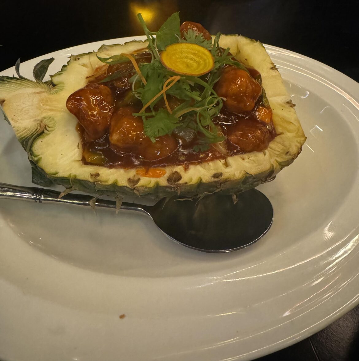 Hot Sweet & Sour Chicken served in cold, hollowed out pineapple