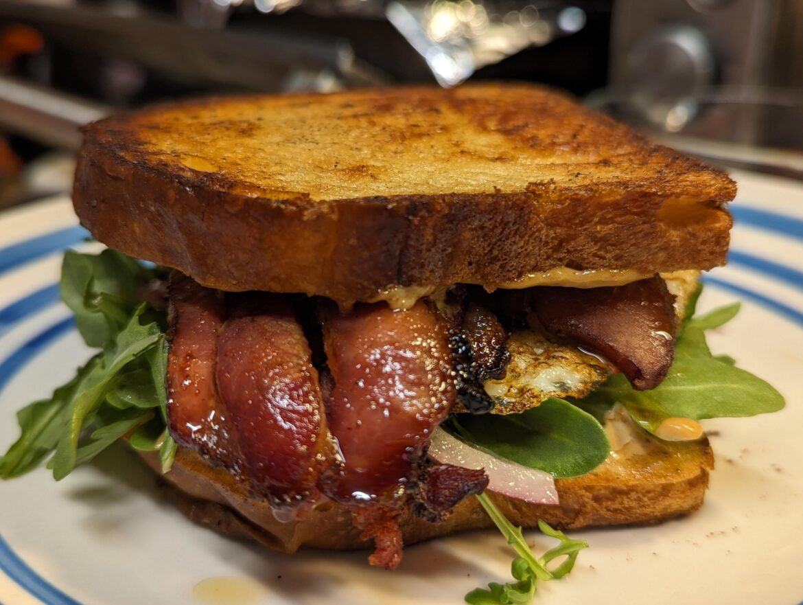 Bacon, egg, and arugula breakfast sandwich