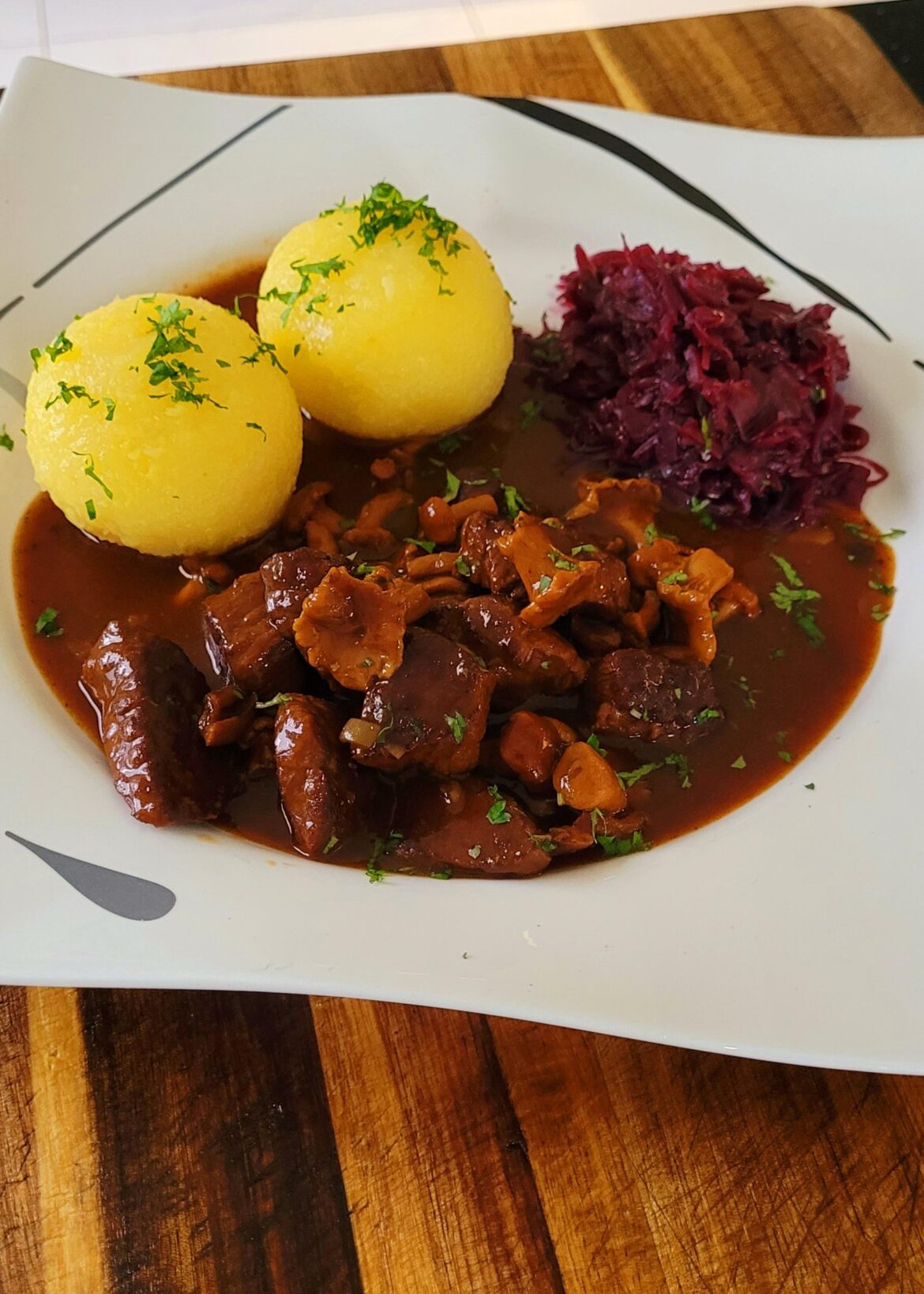 Goulash with chanterelle mushrooms, potato dumplings and braised red cabbage