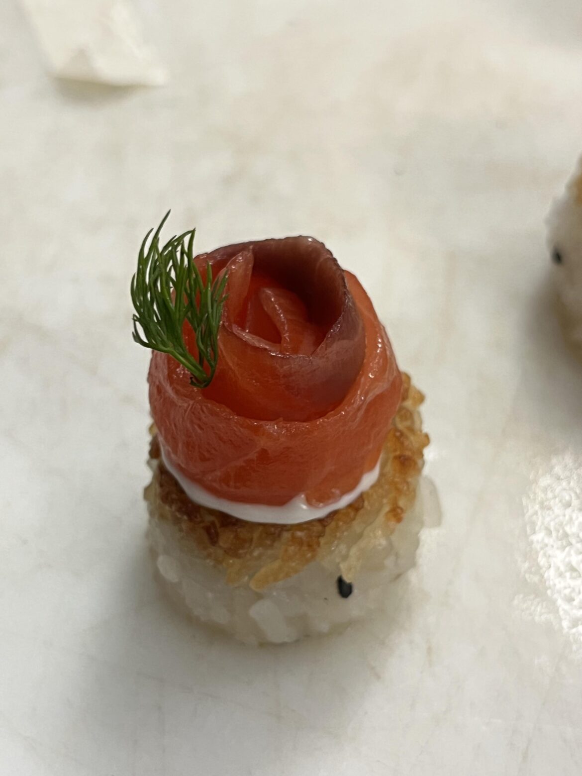 smoked salmon rosette, lemon dill cream, crispy rice cake