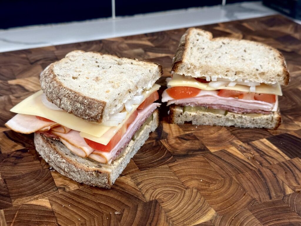 turkey, peppered salami and swiss on rye w/ onion, pickle, tomato, deli mustard and mayo