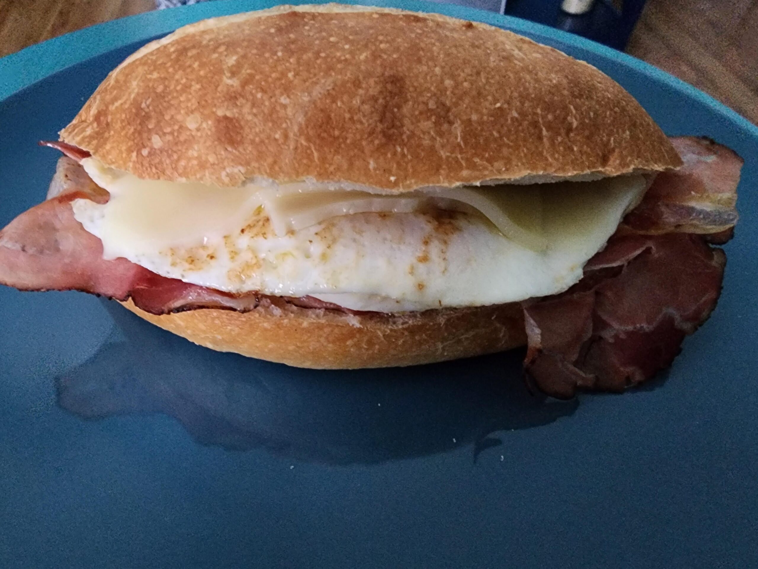 Prosciutto, egg and cheese on a crispy toasted roll. Dining and Cooking
