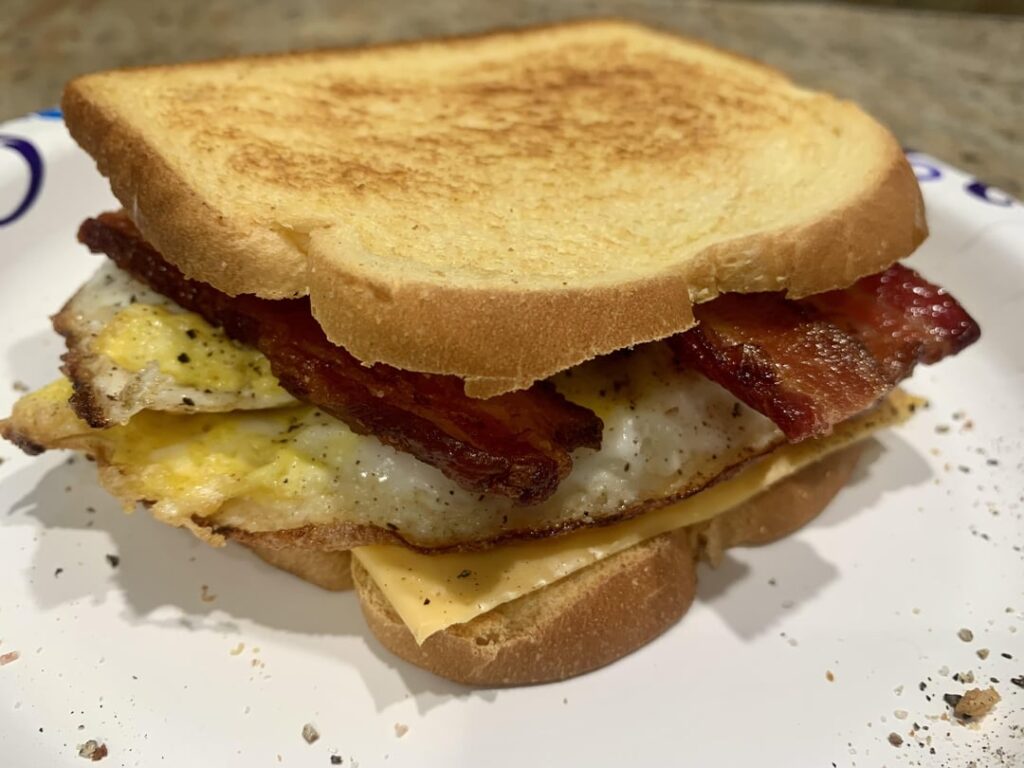 Only had one slice of bread left so I carefully cut it in half to make this bacon, egg and cheese