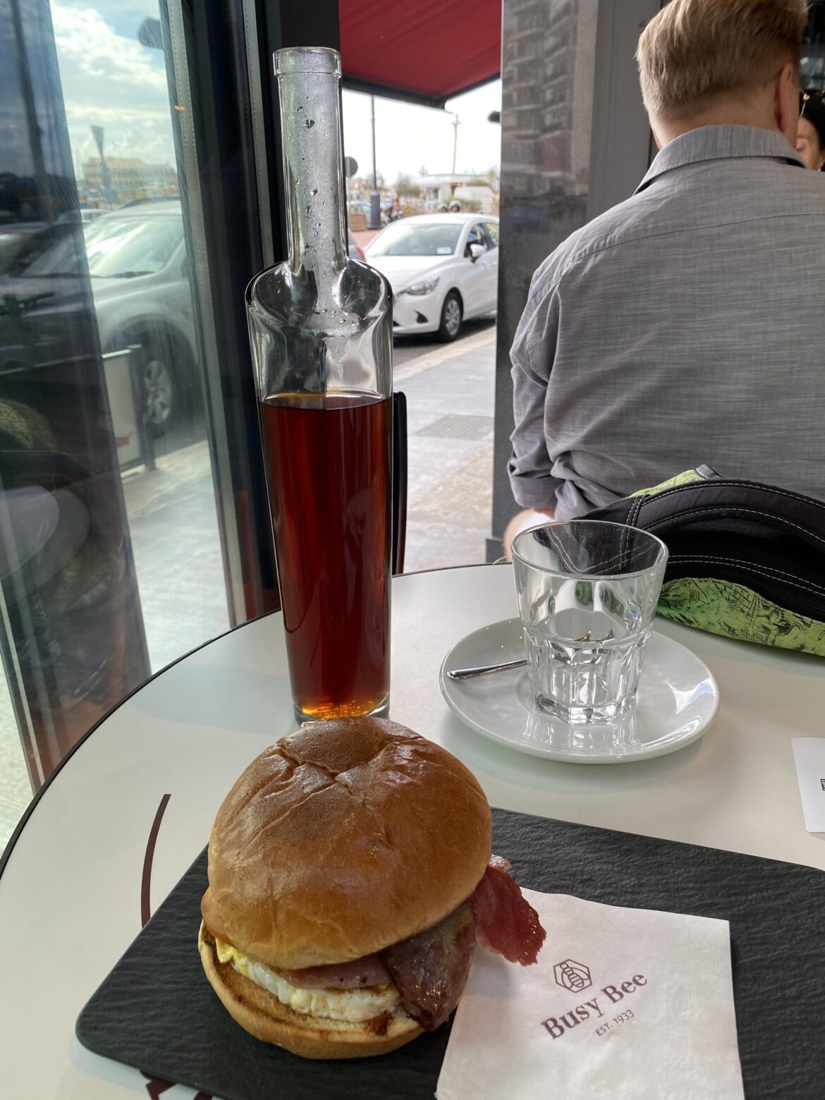 The breakfast bun on the slate is weird, but hot coffee in a bottle without a handle?