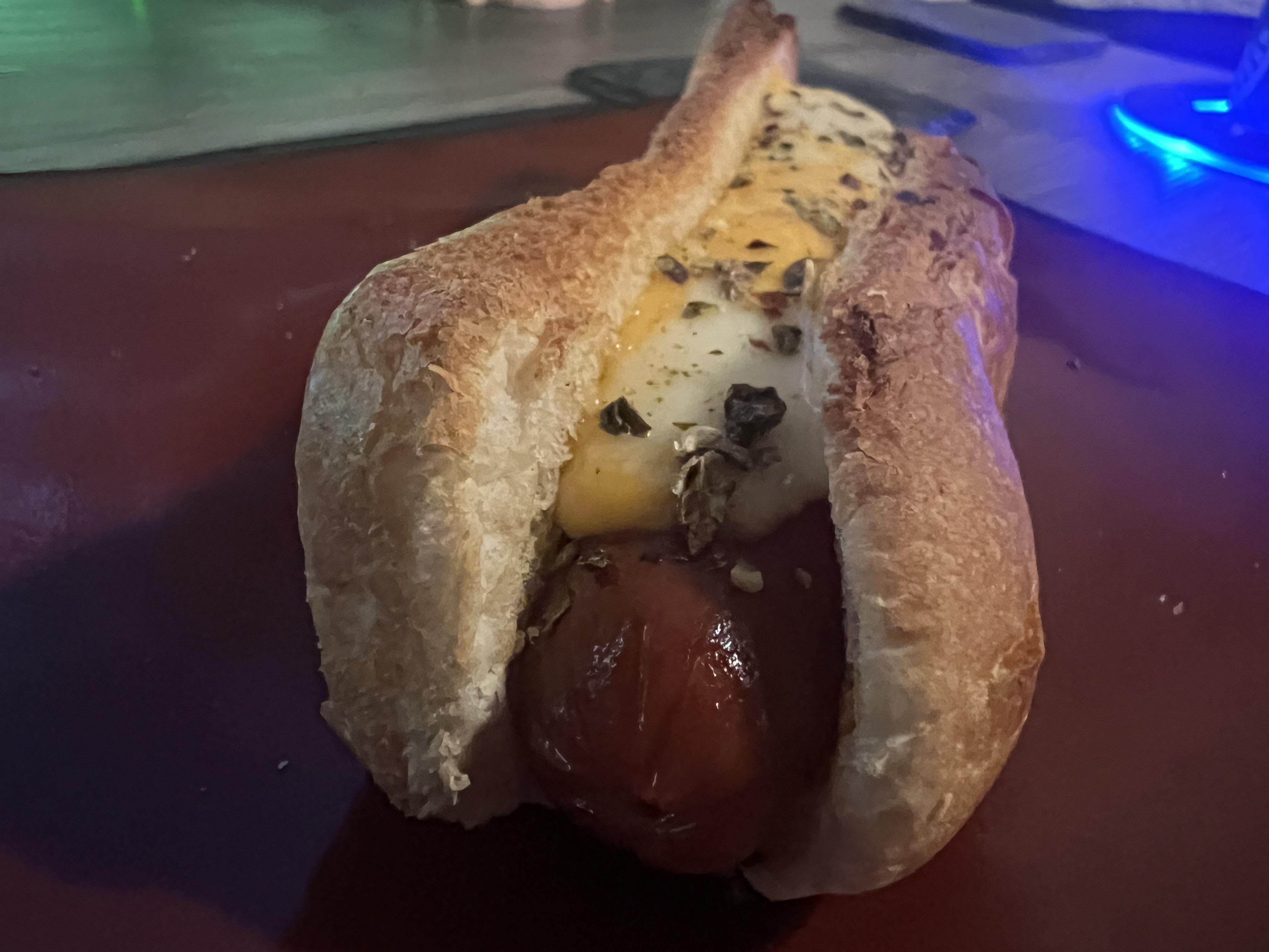 Pan fried hotdog with Colby Jack string cheese, nestled in a bun with