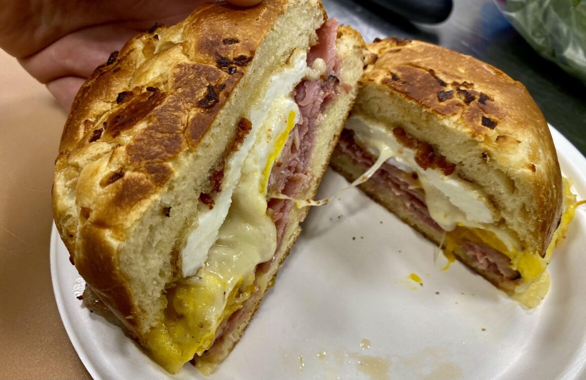 Ham, eggs, swiss and bacon with butter and mayo on an onion brioche.