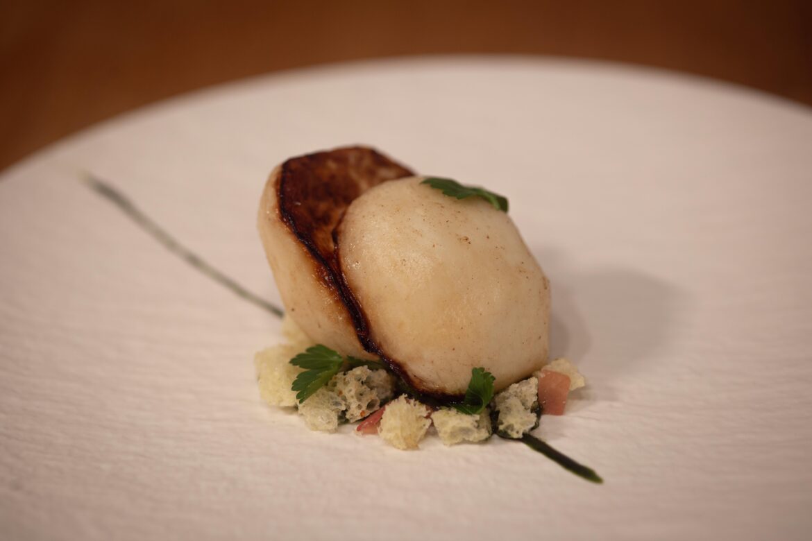 Turnip cooked for 4 hours sous vide, browned in butter, finished with fermented honey; parsley-sesame oil emulsion; brioche croutons; Jamon