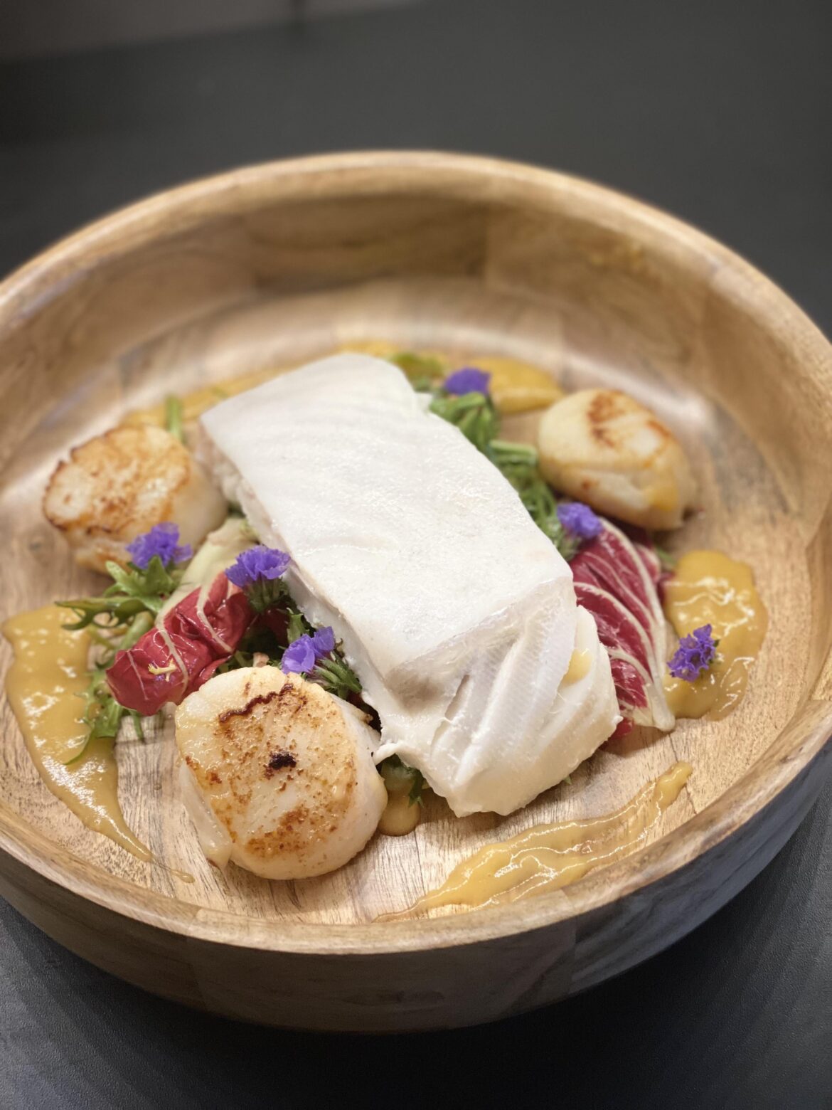 Sou Vide Halibut with seared scallops, frisée, endive and beets salad finished with Fish velouté sauce