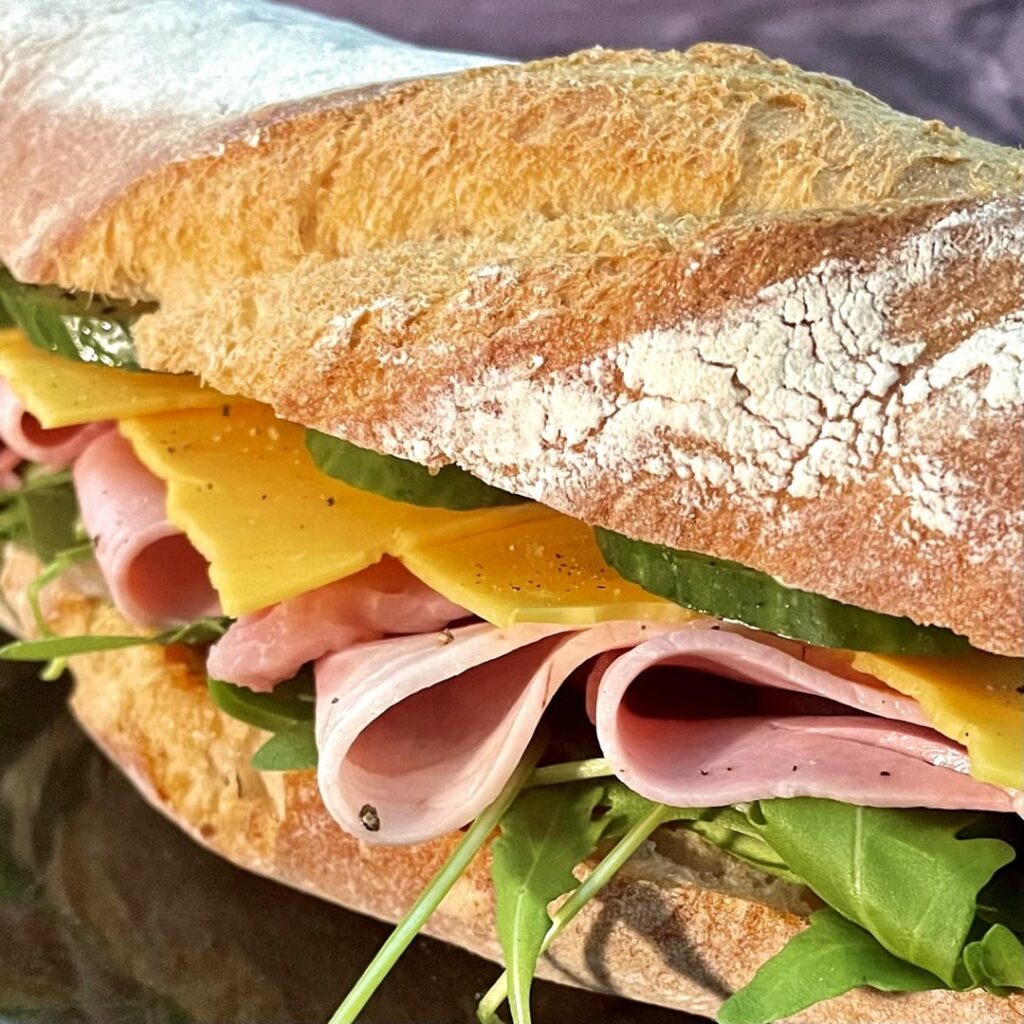 Nothing unusual but always tasty: cheddar, ham, rocket lettuce and cucumber on baguette