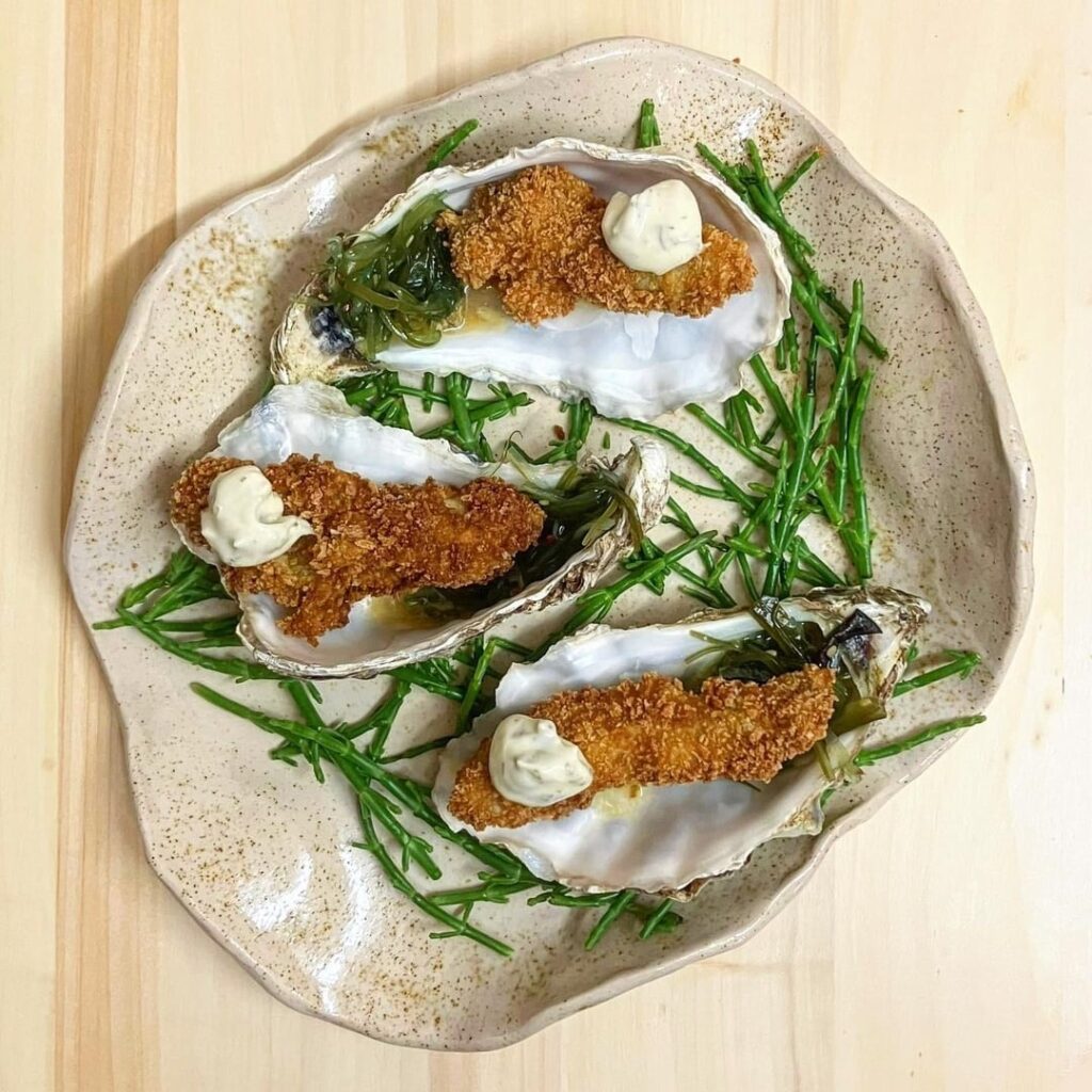 Fried Oysters in a Yuzu Wasabi Vinaigrette, Seaweed Salad and topped with a Tartare Sauce