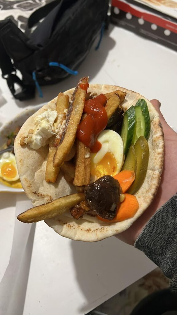 Eggcelent sautéed than air fried shiitakes date bubbies spicy pickle cucumber carrot toasted pine nuts barrel aged feta French fries sriracha pita wrap
