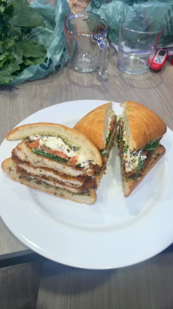 Fried Chicken Cutlets, Roasted Red Bell Pepper, Burrata, Rapini, and Pesto on Toasted Ciabatta Roll
